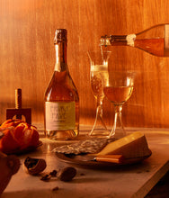 Load image into Gallery viewer, Prima Pave - Rose Brut - Alcohol Free Sparkling Wine in dark wintery light with cheese