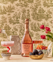 Load image into Gallery viewer, Prima Pave - Rose Dolce - Alcohol Free Sparkling Wine with glass and fruit in front of wallpaper
